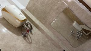 a bathroom with a hair dryer and a mirror at VISHNOO STAYS Sunny Morning Room in Nawāgaon +16 photos