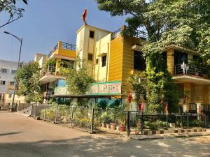 a yellow building with a fence in front of it at VISHNOO STAYS Sunny Morning Room in Nawāgaon