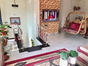 a living room with a mirror and a tv at VISHNOO STAYS Sunny Morning Room in Nawāgaon