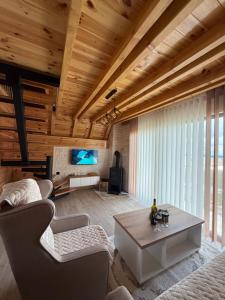 a living room with a couch and a table at Zov planine in Žabljak
