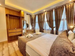 a hotel room with two beds and large windows at Attalos Villa in Antalya +76 photos