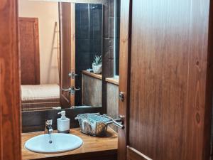 a bathroom with a sink and a mirror at Le Mirasol Appart-hôtel in Enveitg +38 photos