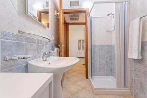a bathroom with a sink and a shower at La Casa Azzurra in Tertenìa +33 photos