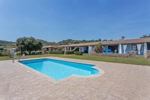 a swimming pool in front of a house at La Casa Azzurra in Tertenìa