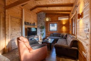 a living room with couches and a tv in a cabin at Zabes Home in Zabes