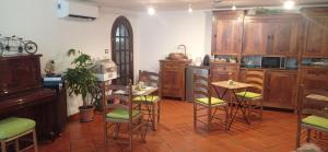 a kitchen with wooden cabinets and a table and chairs at La Casa dei Daini in Ronciglione