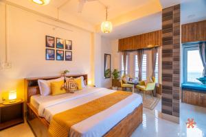 a bedroom with a bed and a window at Zostel Guwahati in Guwahati +24 photos