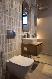 a bathroom with a toilet and a sink at Horizon 180 in Varna City +52 photos