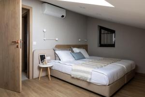 a bedroom with a large bed and a small table at Horizon 180 in Varna City