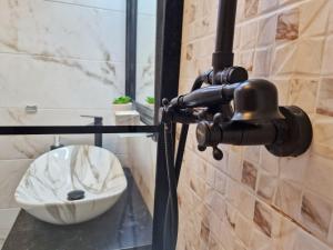 a bathroom with a white bowl on a counter at Casa Anitta in Buşteni