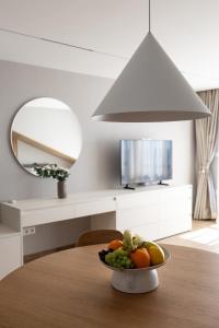 a bowl of fruit on a table in a room at Horizon 180 in Varna City