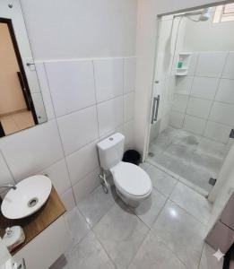 a bathroom with a toilet and a sink and a shower at Hostel Londrina I in Londrina