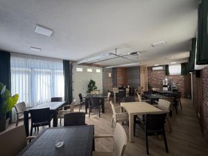 a restaurant with tables and chairs in a room at Villa Dana in Ohrid