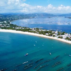 an aerial view of a beach with boats in the water at Ocean Breeze Bungalow in Sông Cầu