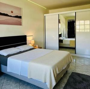 a bedroom with a large bed in a room at Hostel Londrina I in Londrina