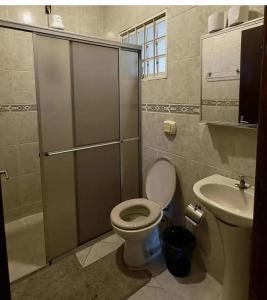 a bathroom with a toilet and a sink at Hostel Londrina I in Londrina