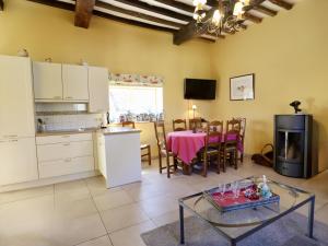 a kitchen and living room with a table and a kitchen and a dining room at La Tour de la Chapelle in Couthuin