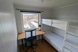 a small room with a desk and a window at Seaview Country House in Pettvik