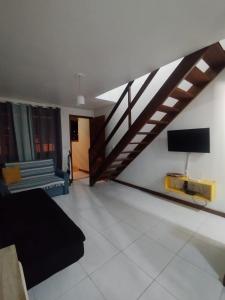 a living room with a staircase and a couch at Recanto Vista Mar - Costa Verde, Mangaratiba in Mangaratiba