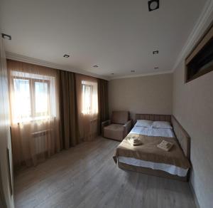 a bedroom with a bed and a chair in it at Livana Guesthouse - Goris in Goris