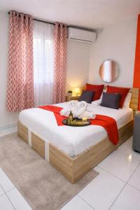 a bedroom with a large bed with red accents at Dreamy Oasis in Marigot