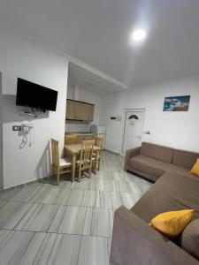 a living room with a couch and a table at Vila Mario in Ksamil