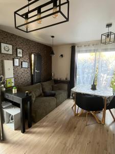 a living room with a couch and a table at Maison cosy au calme in La Colle-sur-Loup