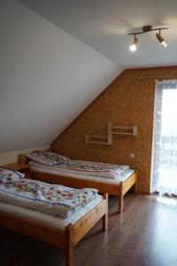 three beds in a room with a attic at Domek u Johnnego 28 in Piwniczna Zdrój