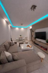 a living room with a couch and a tv at Rhodes Nest in Ixia