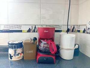a red coffee maker sitting on a counter in a kitchen at villa hermosa cayma in Yanahuara
