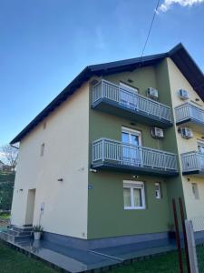 a building with balconies on the side of it at Apartmani Zeleni Horizont in Bratunac
