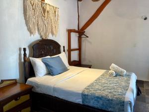 a bedroom with a bed with blue and white pillows at Golden Paradise Oceanfront - Self Check in in Holbox Island