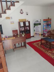 a living room with a desk and a table at Regal Montara in Nuwara Eliya