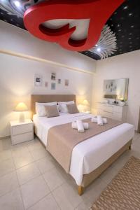 a bedroom with two beds and a red ceiling at Rhodes Nest in Ixia