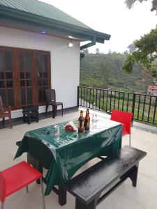 a table with bottles and drinks on a patio at Regal Montara in Nuwara Eliya