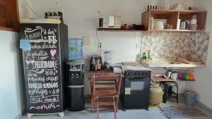 a kitchen with a black refrigerator with writing on it at Casa Sophi in Cruz