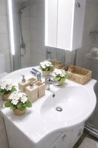 a bathroom sink with flowers in baskets on it at Rhodes Nest in Ixia