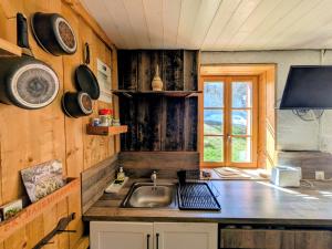 a small kitchen with a sink and a window at Le refuge de Marius - logement de colpoteur in Albiez-Montrond