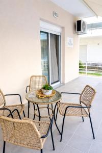 a patio with a table and chairs on a balcony at Rhodes Nest in Ixia