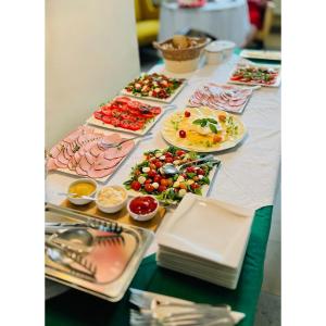 a table with many plates of food on it at Hotel pod Dębem in Szydłowiec +2 photos