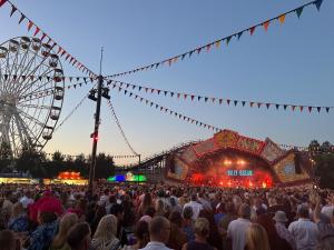 a crowd of people at a concert with a ferris wheel at 2 Sea View Margate in Margate