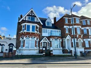 a large red brick house with white windows at 2 Sea View Margate in Margate