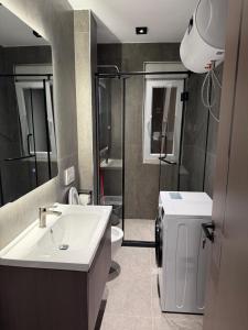 a bathroom with a sink and a toilet at Casa Del Sol - Shengjin in Shëngjin