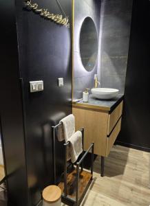 a bathroom with a sink and a mirror at Fleur de Lune in Amiens