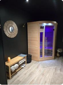 a room with a sauna with a table and a mirror at Fleur de Lune in Amiens +1 photo