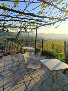 two chairs and a table on a patio with a view at Rooms Serafin in Motovun