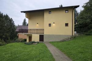 a house with a balcony on the side of it at Edi in Sarajevo