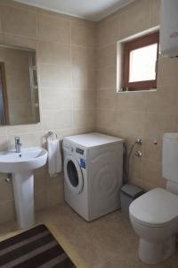 a bathroom with a washing machine and a sink at Edi in Sarajevo +21 photos