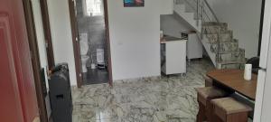 a room with a staircase and a stone floor at Colt de rai in Secăria