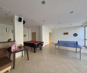 a living room with two ping pong tables in it at Seaside Dream in Dolen Bliznak
